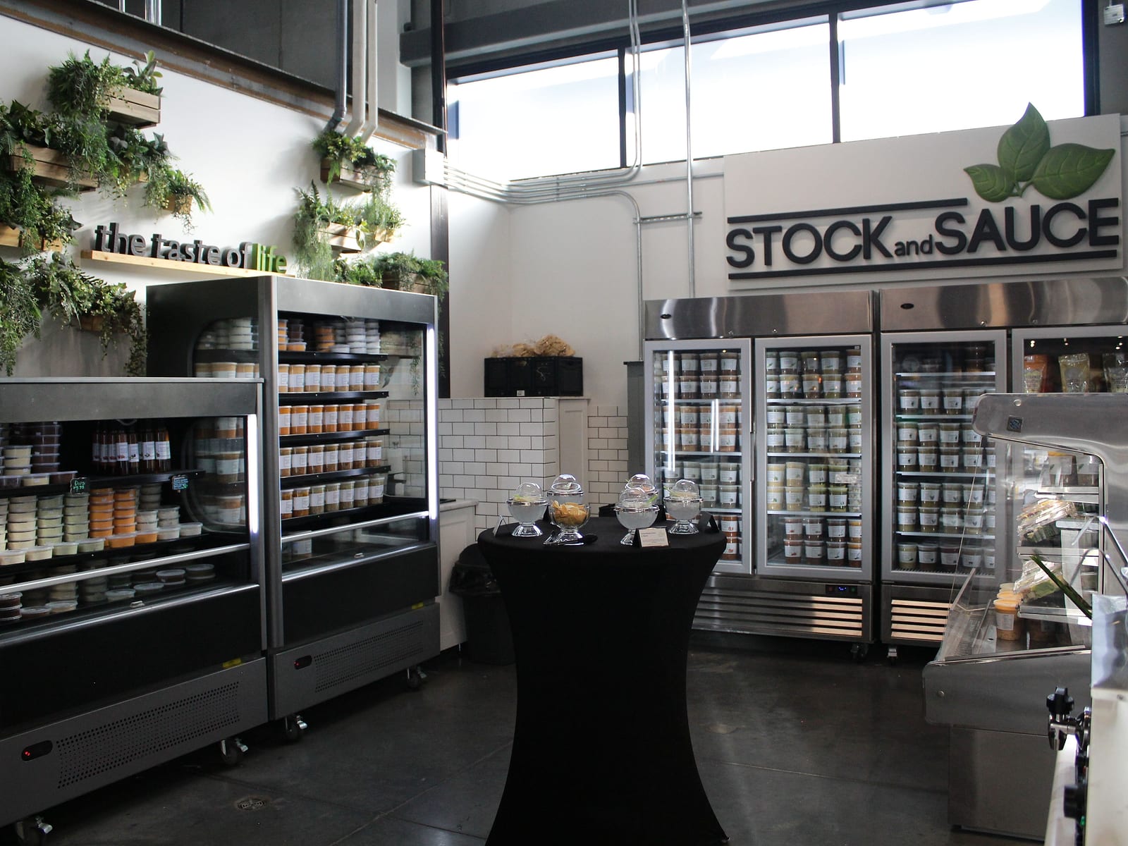 Inside the Stock & Sauce store, shelves and fridges stocked with soups and sauces