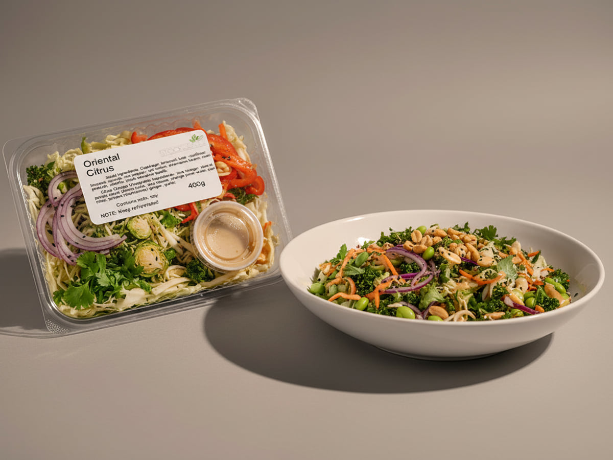 Tray of Stock & Sauce Oriental Citrus Salad beside a bowl of it tossed and served — red onion, red pepper, edamame and cilantro