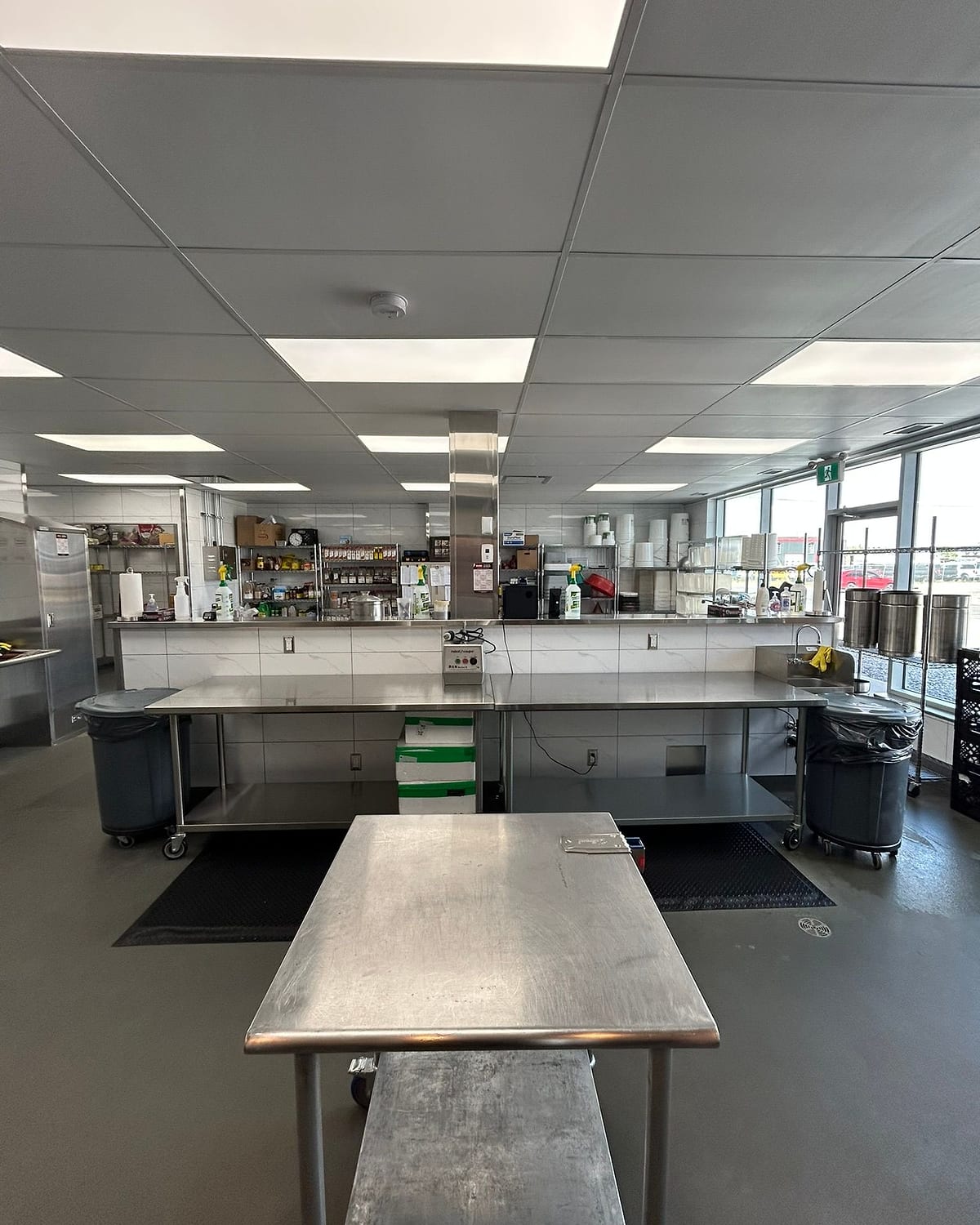 Inside the Stock & Sauce kitchen — the line of stainless benches and simmering stock pots