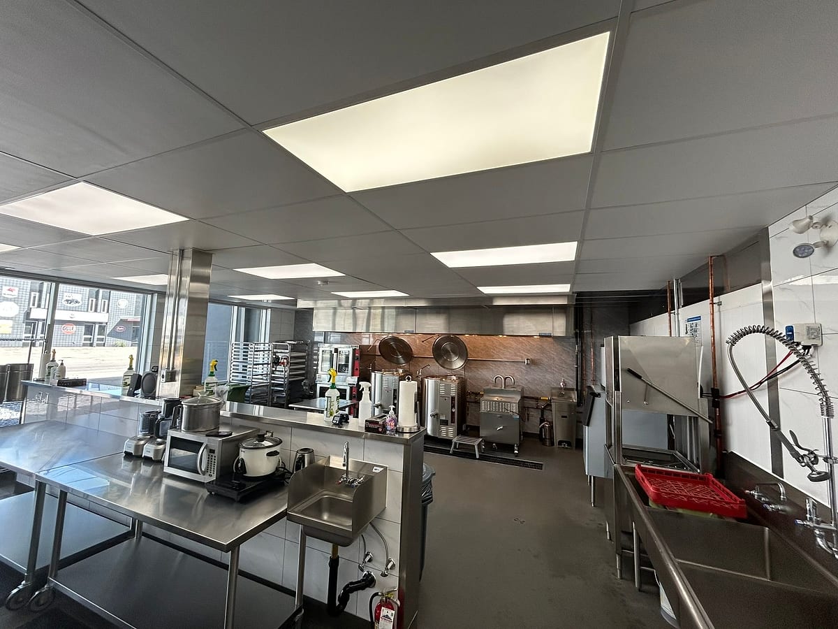 The Stock & Sauce commercial kitchen in Calgary, stainless prep benches and stock pots
